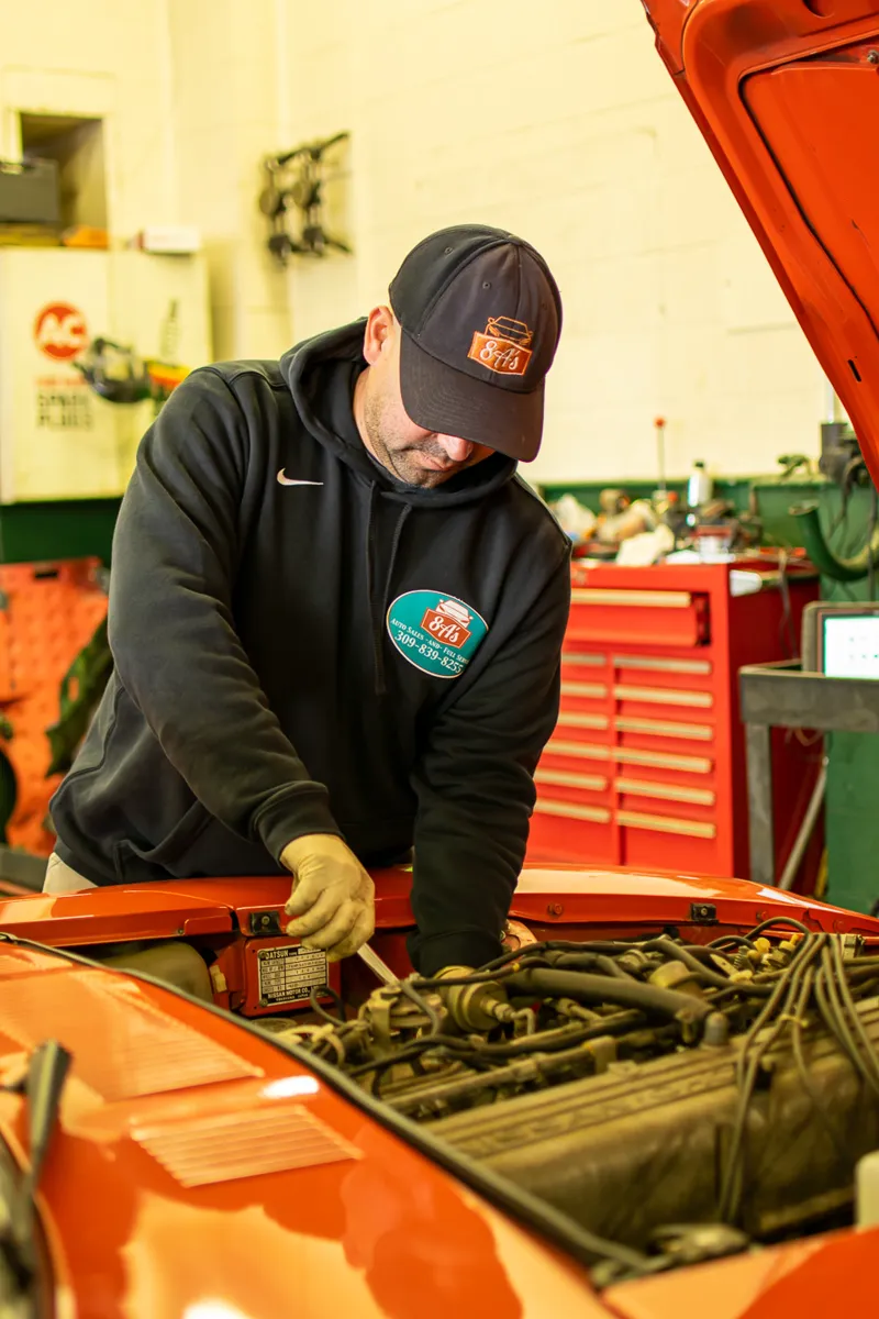 8A's mechanic at work under the hood in the Peoria shop